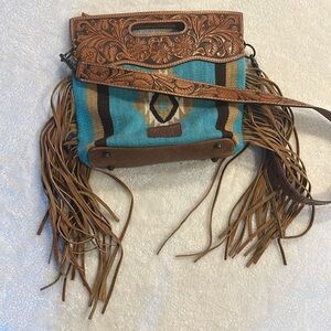 American darling fringe saddle bag with leather strap.